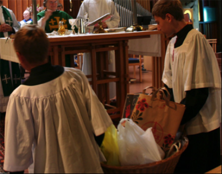 Acolytes bring forward Sunday donations for the Berkeley Food Pantry