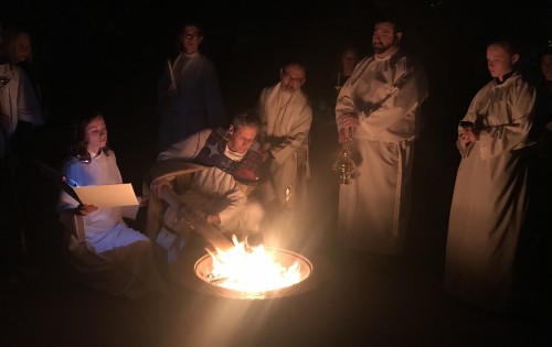 Lighting the paschal candle from the new fire at the Easter Vigil.