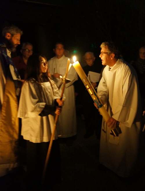 Lighting the acolyte candles from the paschal candle.